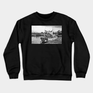 Traditional Broads boat moored to a wooden quay heading Crewneck Sweatshirt